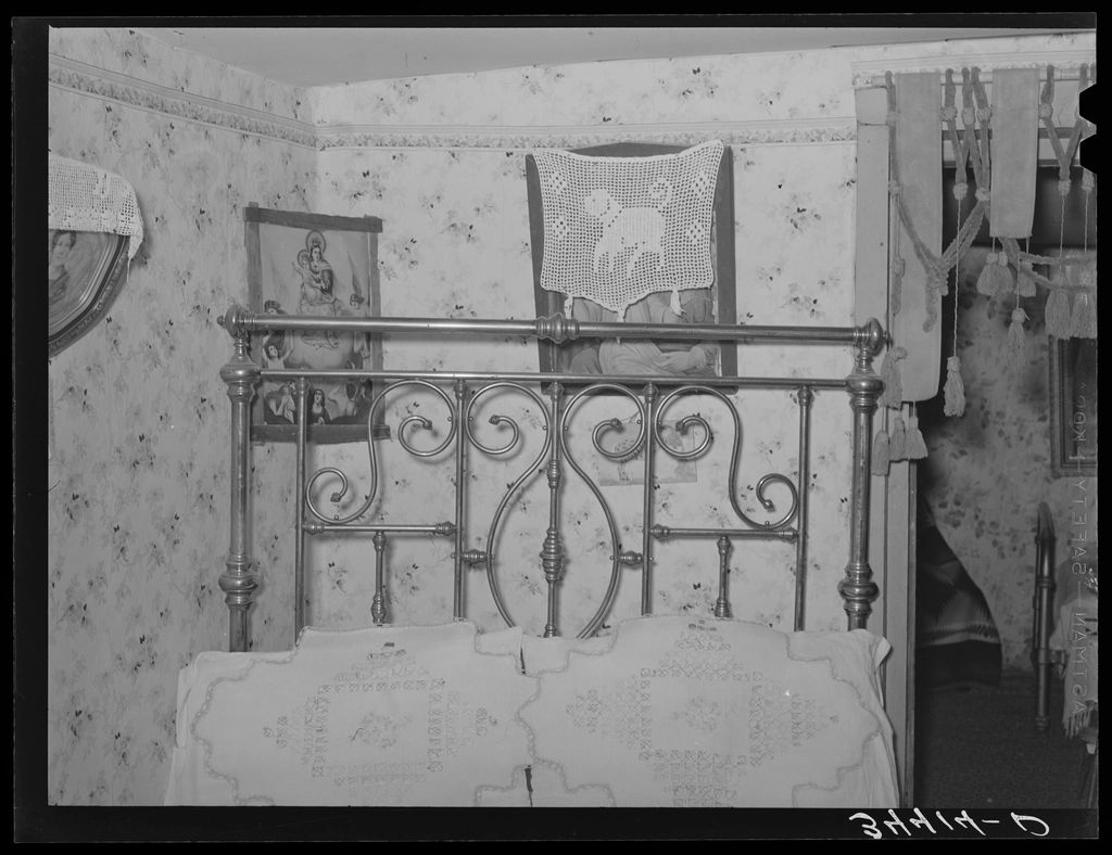 A guest room with a large bed and soft lighting